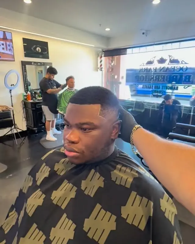 Inside Ocean Park Barbershop, with the shop logo on the front window