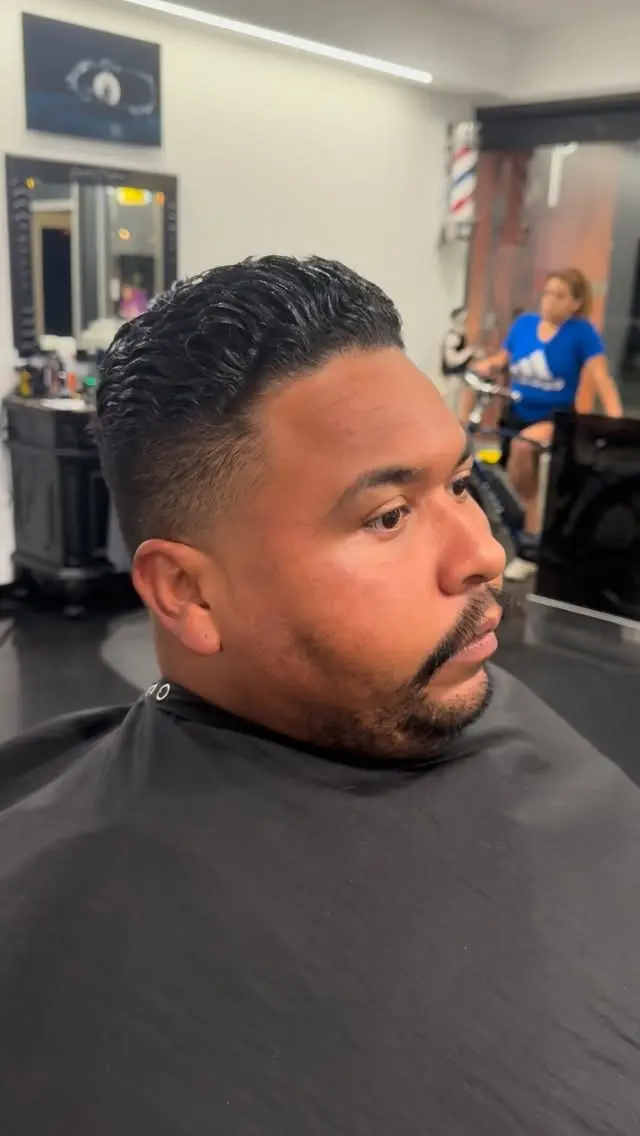 Side-part haircut with a tidy beard at Ocean Park Barbershop