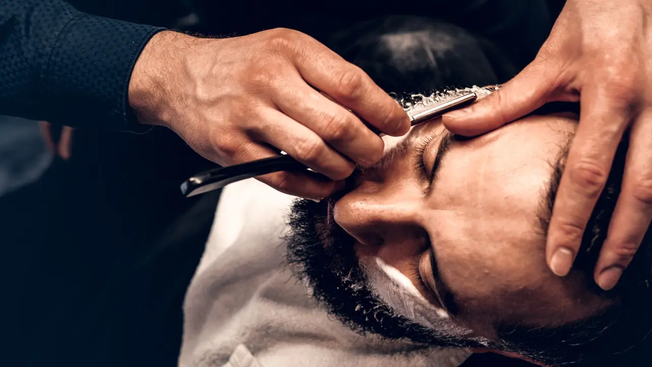 Straight razor shave around a client's beard line