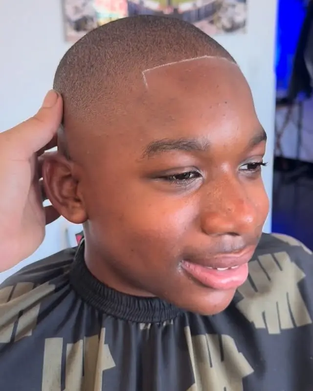 Smiling young client with a fresh fade and lineup at Ocean Park Barbershop